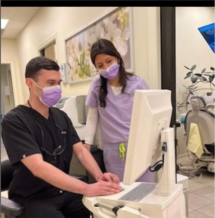 two dental staff members laughing