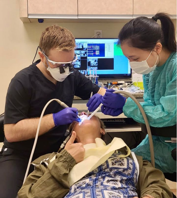 two dental staff members laughing