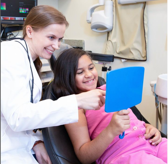 two dental staff members laughing